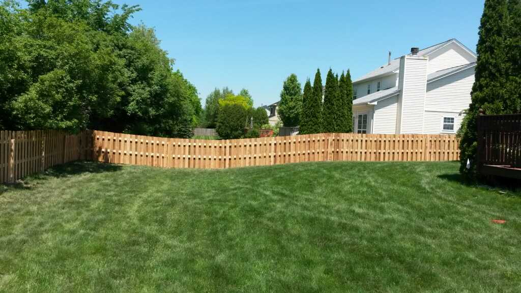 A wooden fence on uneven ground.